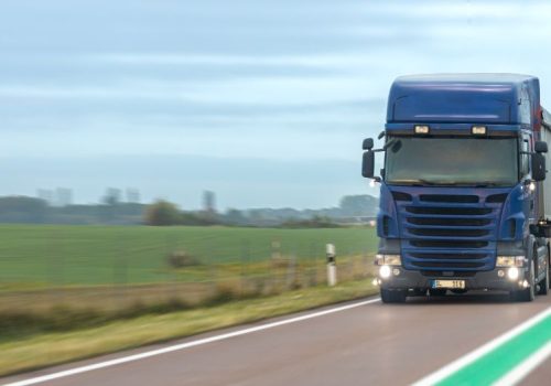blue-truck-rural-highway-with-green-line-logistics-motion (1)